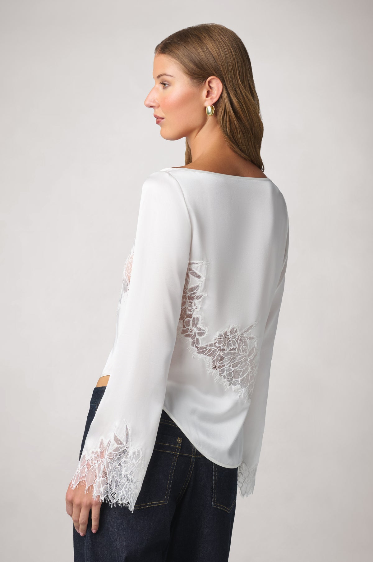Kiki de Montparnasse fluid silk charmeuse and sheer Iris lace long-sleeve top, shown from the side with an open side and delicate tie detailing.