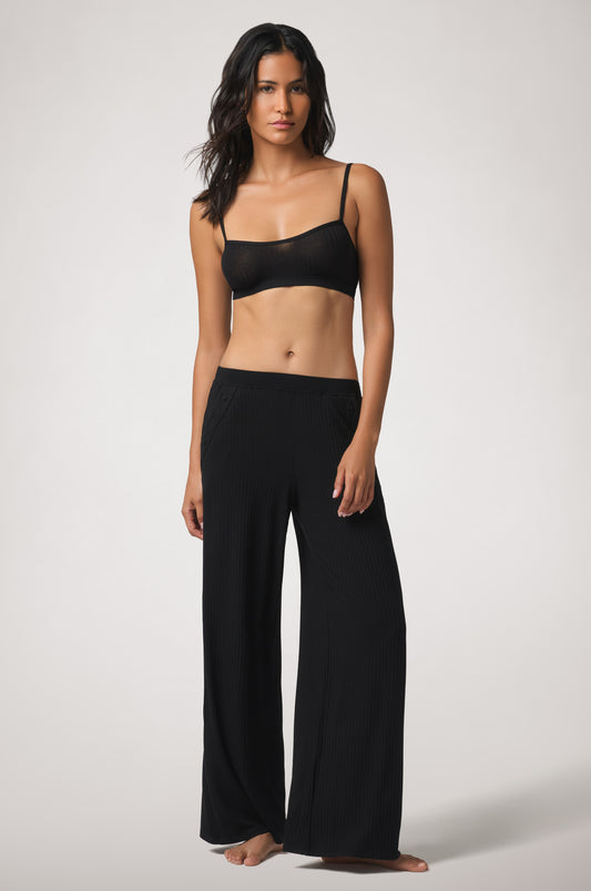 Soft rib-knit bralette with a minimal silhouette, gently shaped cups, slim adjustable straps, and subtle tonal embroidery at the center front.