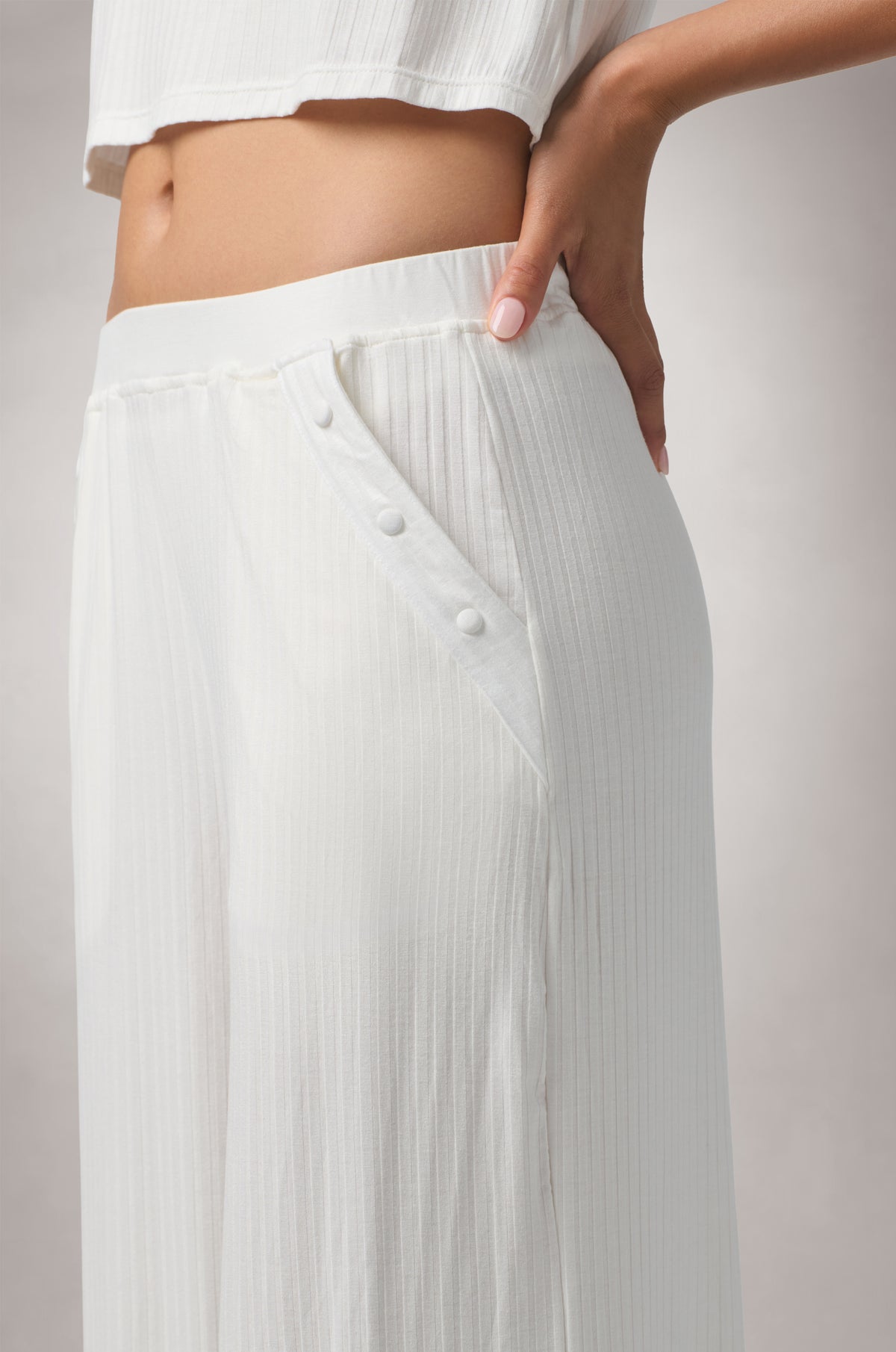Kiki de Montparnasse Le Boy Track Pant in soft stretch rib knit with a relaxed silhouette and fabric-covered buttons at the hips, shown from the side.
