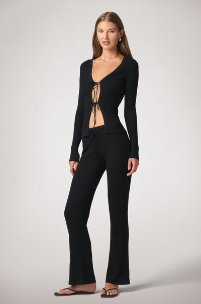 Crafted from soft rib knit, the Rib Knit Wide Pant is designed with a fitted silhouette through the hips and thighs before gently flaring toward the hem. A delicate tie waistband completes the effortless feel.

