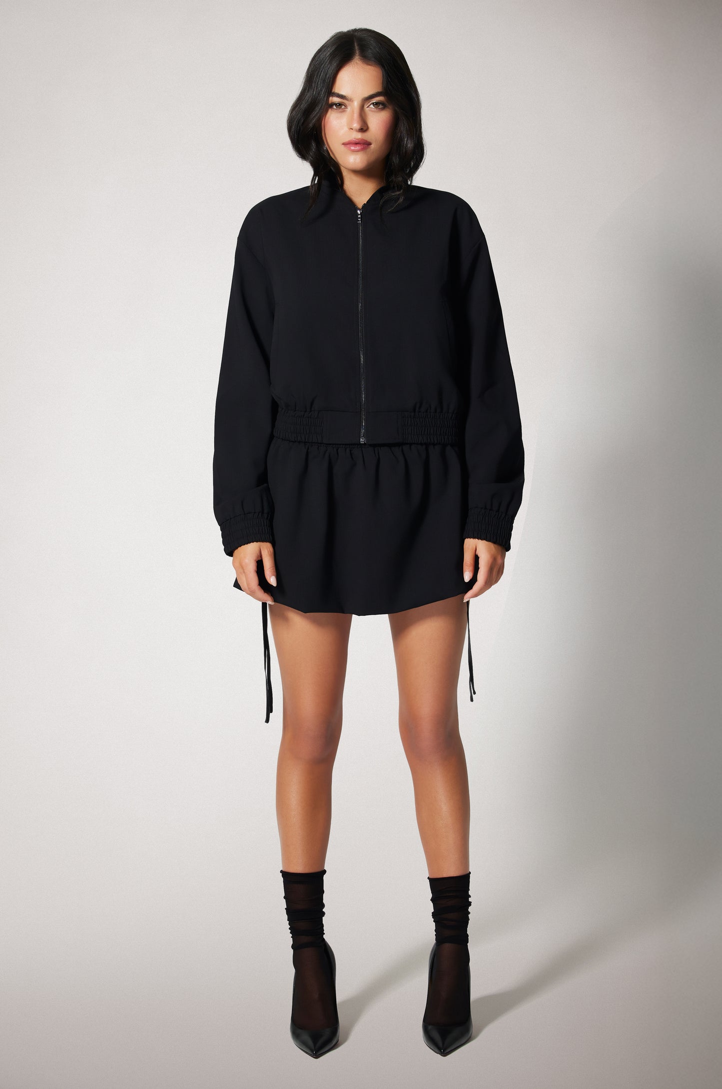 Black Cropped Cinched End Mock Neck Gold Zip Up Suiting Bomber Jacket Front