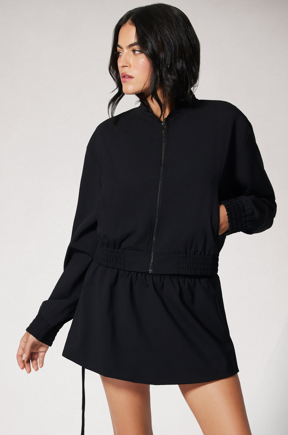 Black Cropped Cinched End Mock Neck Gold Zip Up Suiting Bomber Jacket Front
