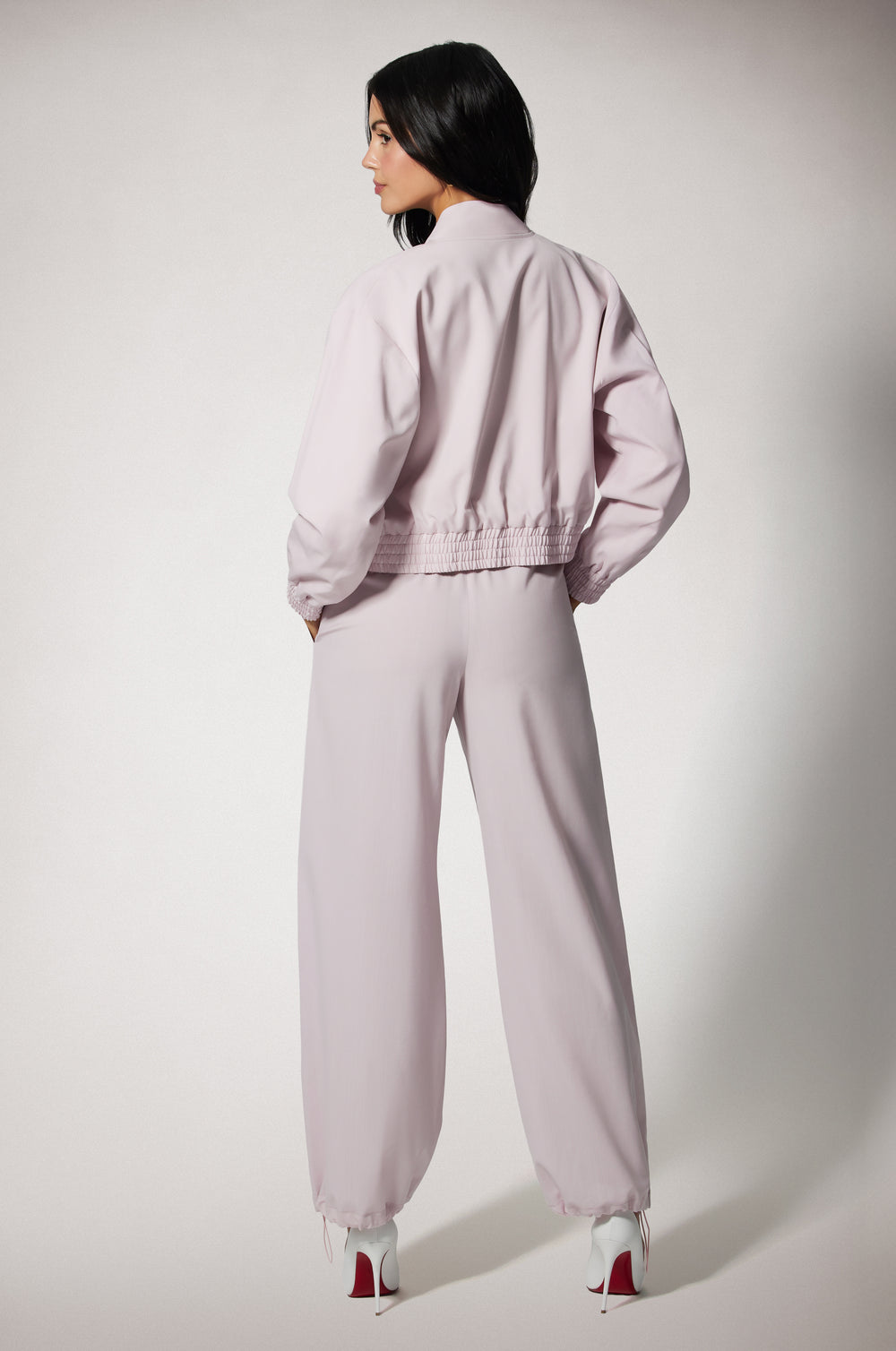 Light Pink Cropped Cinched End Mock Neck Gold Zip Up Bomber Jacket and Pant Back